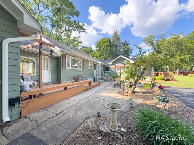 a view of house with outdoor space and swimming pool