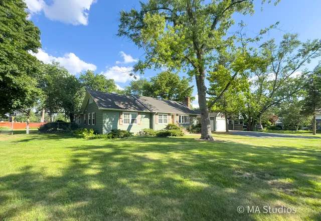 a view of house with yard outdoor seating and barbeque oven