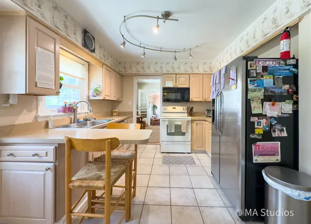 a kitchen with stainless steel appliances granite countertop a refrigerator and a stove top oven