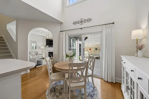 a kitchen with stainless steel appliances granite countertop a sink a stove a refrigerator a washer dryer and white cabinets
