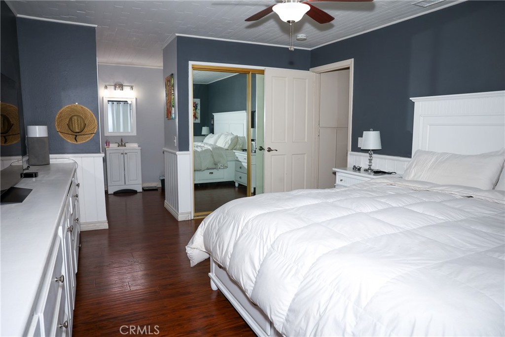 2216 El Capitan Drive Riverside, CA 92506 - Photo 12 of 39 a bedroom with a bed and a chandelier