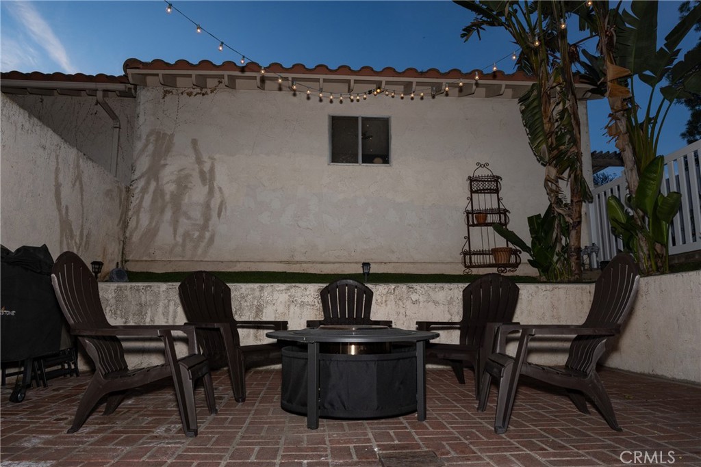 2216 El Capitan Drive Riverside, CA 92506 - Photo 23 of 39 a view of a patio with table and chairs a barbeque with wooden floor and fence