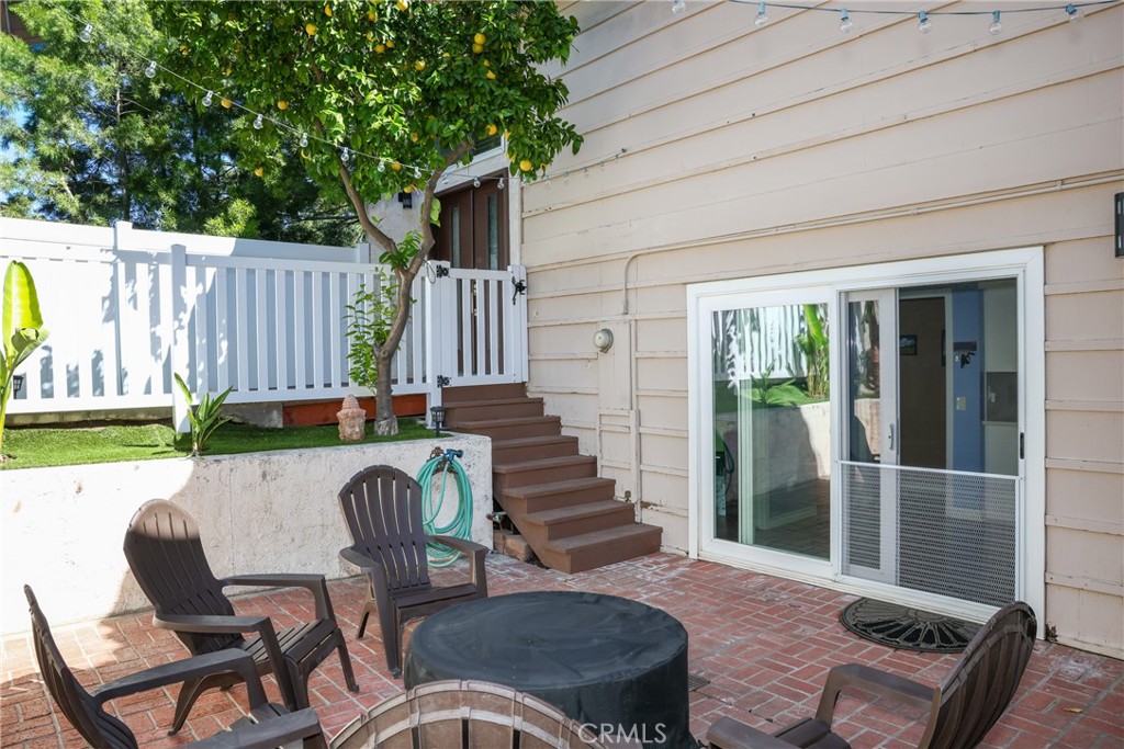 2216 El Capitan Drive Riverside, CA 92506 - Photo 25 of 39 a view of a patio with table and chairs with wooden floor and fence