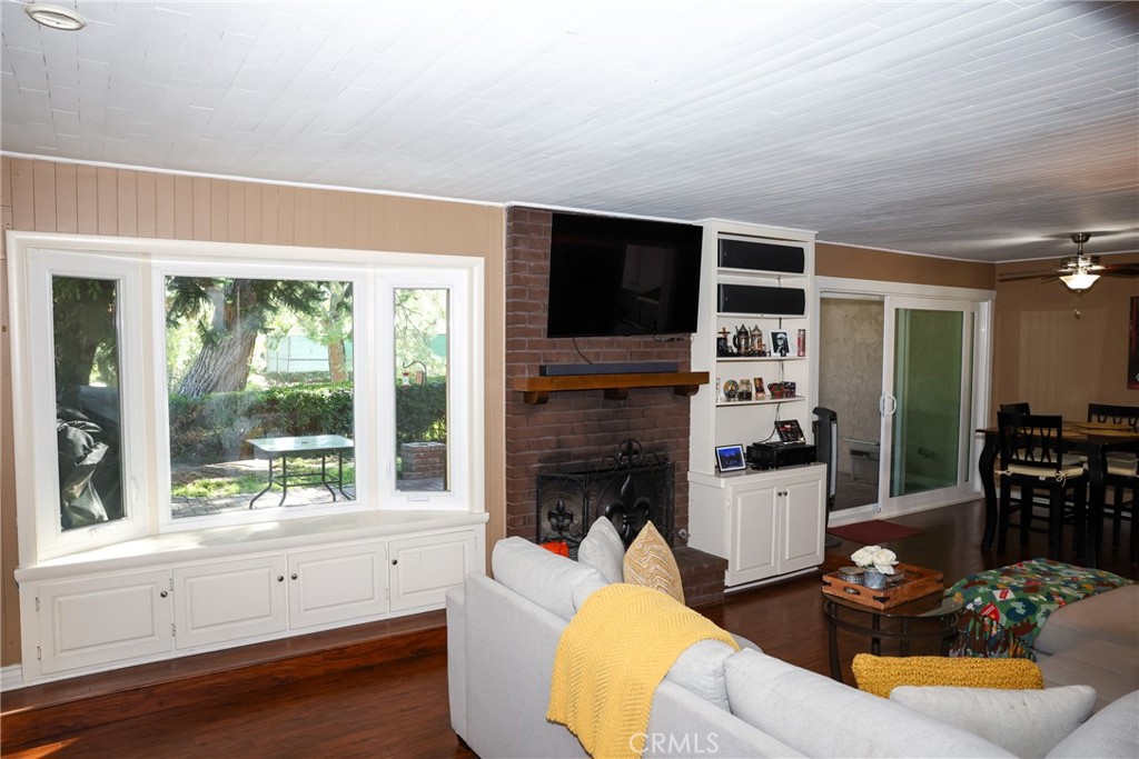 2216 El Capitan Drive Riverside, CA 92506 - Photo 3 of 39 a living room with furniture a fireplace and a flat screen tv