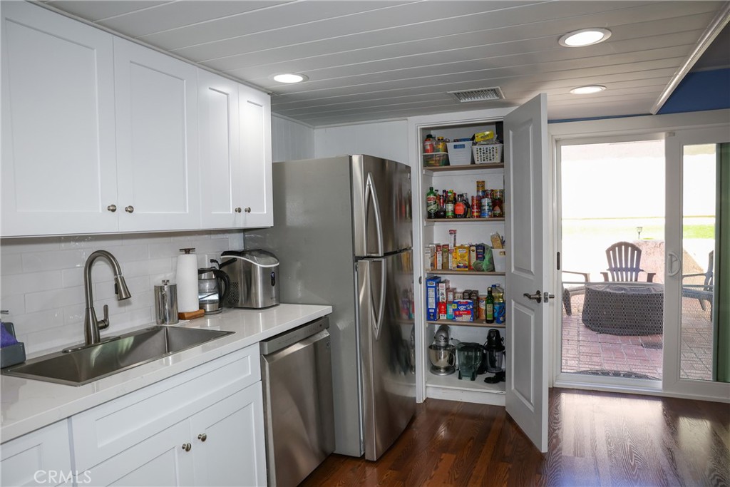 2216 El Capitan Drive Riverside, CA 92506 - Photo 8 of 39 a kitchen with refrigerator and cabinets