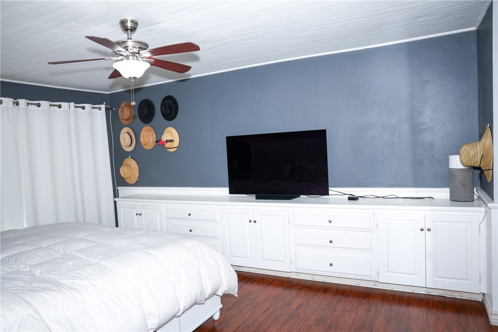 2216 El Capitan Drive Riverside, CA 92506 - Photo 10 of 39 a bedroom with a bed and a flat tv screen on dresser