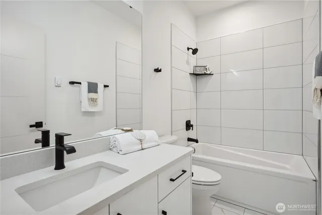 a bathroom with a sink a toilet and a bathtub