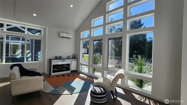 a living room with furniture and a floor to ceiling window