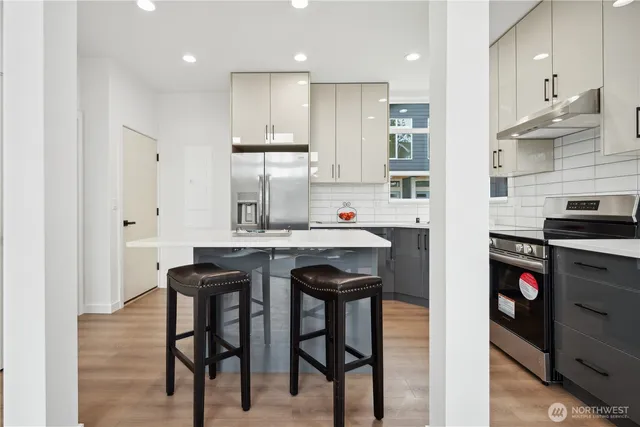 a kitchen with refrigerator and cabinets