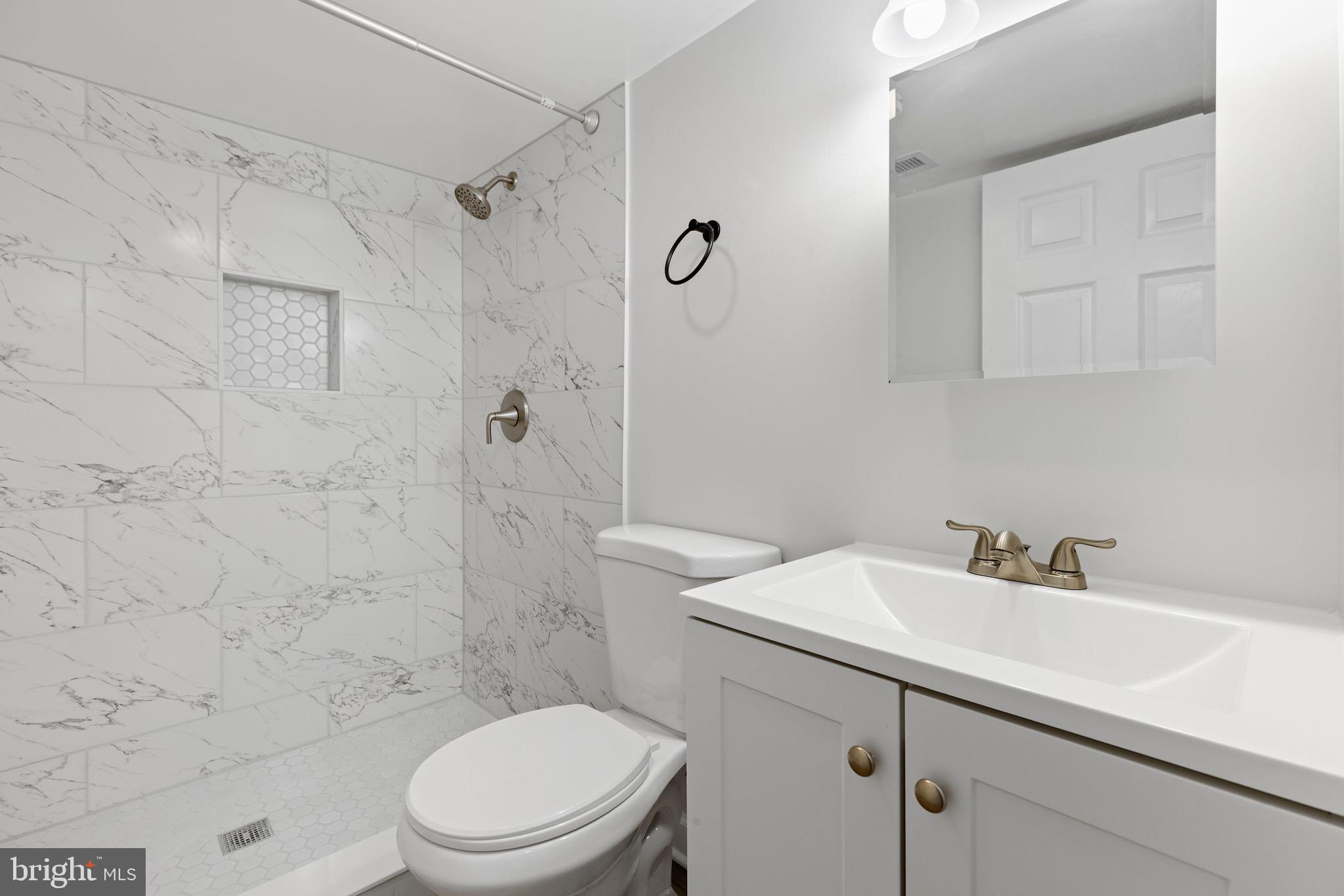 8337 Philadelphia Road Rosedale, MD 21237 - Photo 15 of 19 a bathroom with a sink a toilet and shower