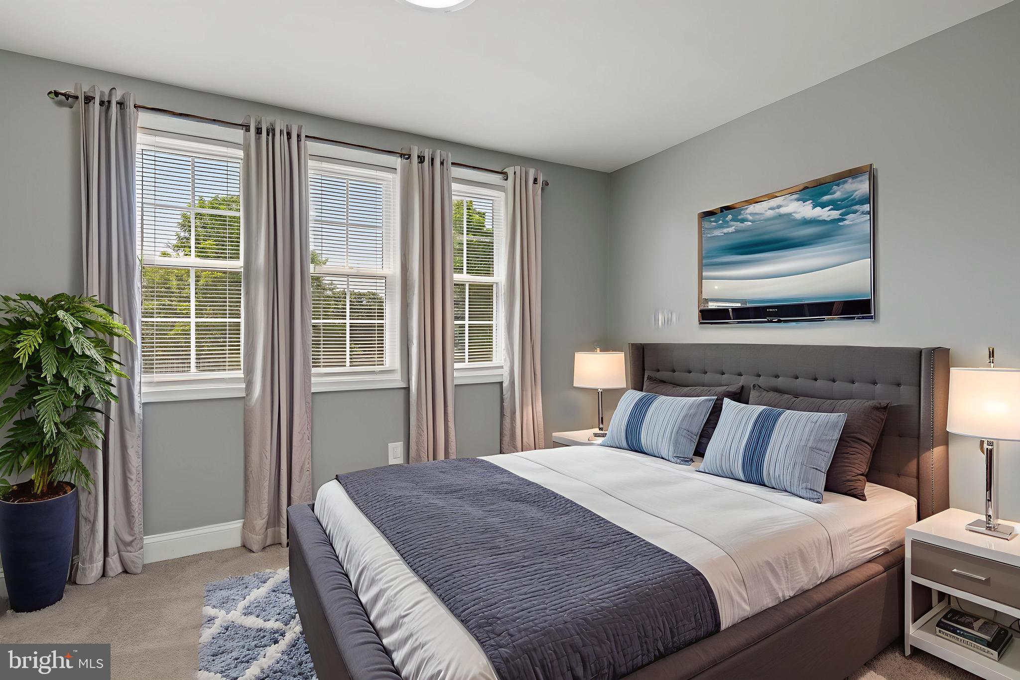 8337 Philadelphia Road Rosedale, MD 21237 - Photo 8 of 19 a bedroom with a large bed and a potted plant