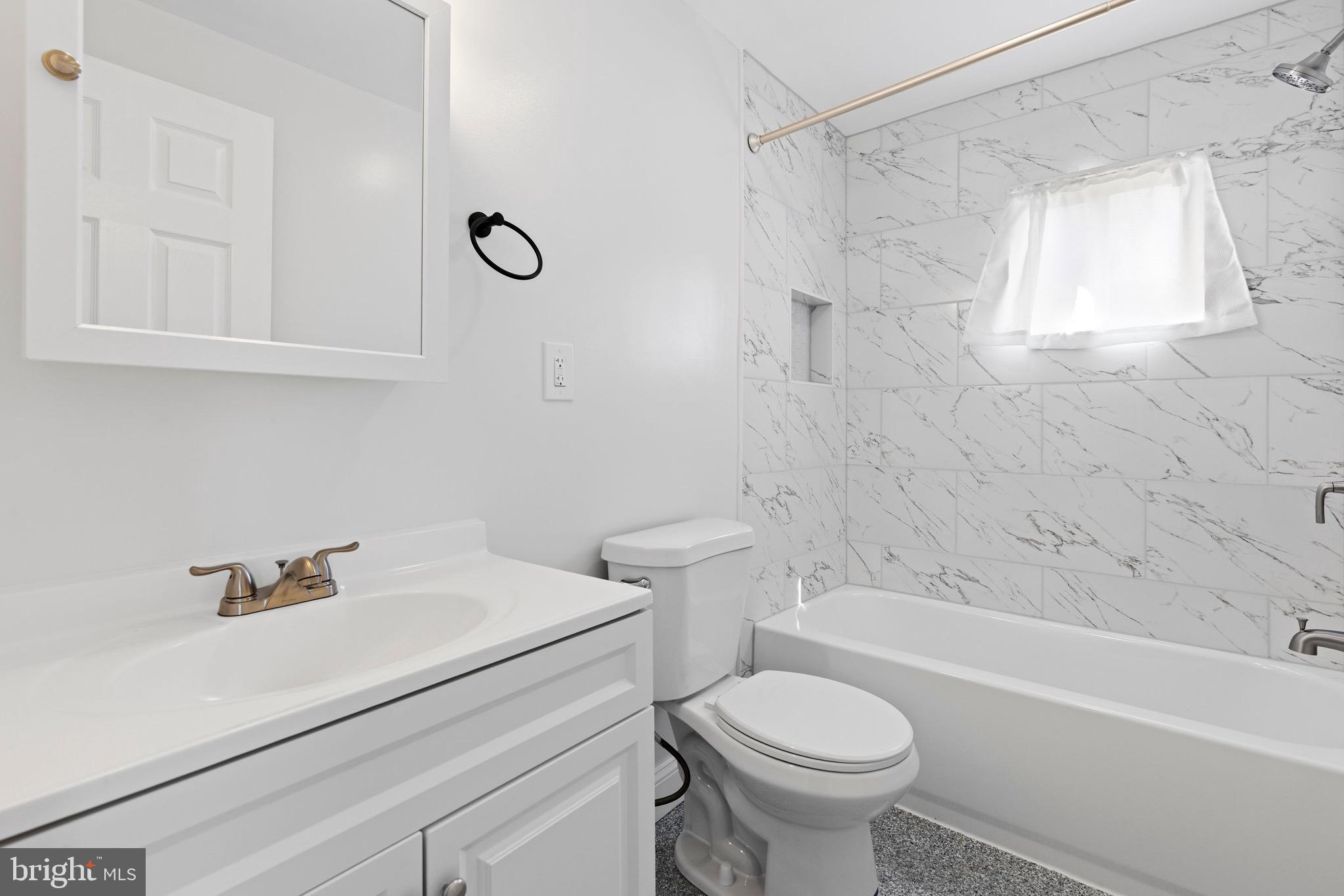 8337 Philadelphia Road Rosedale, MD 21237 - Photo 9 of 19 a bathroom with a sink toilet and shower