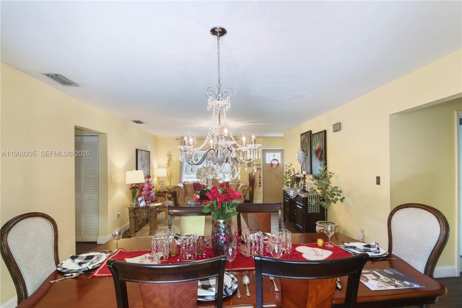 16323 Southwest 103rd Place Miami, FL 33157 - Photo 11 of 42 a view of a dining room with furniture and chandelier