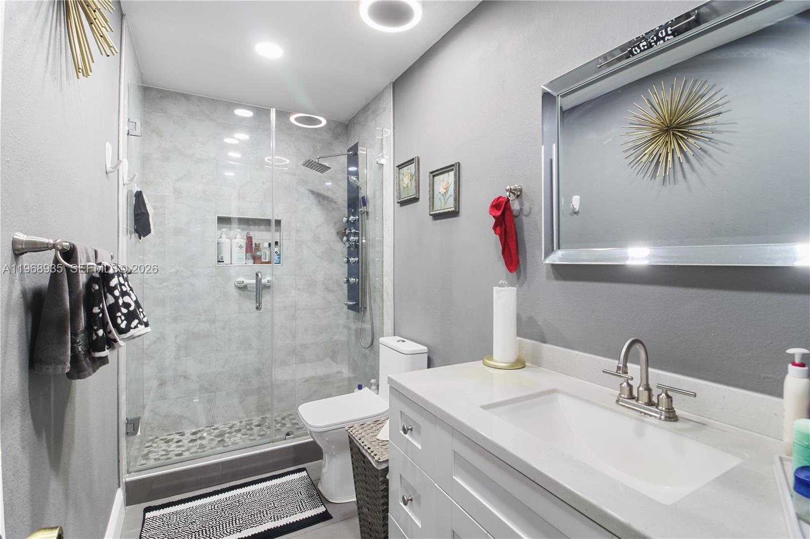 16323 Southwest 103rd Place Miami, FL 33157 - Photo 15 of 42 a bathroom with a granite countertop sink a toilet and a shower