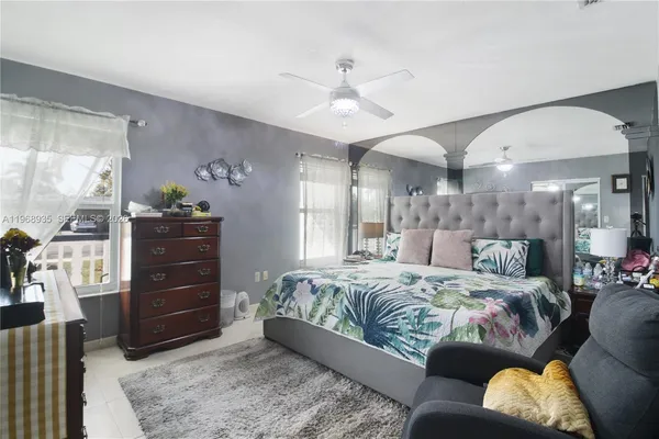 a large bedroom with a bed and a dresser