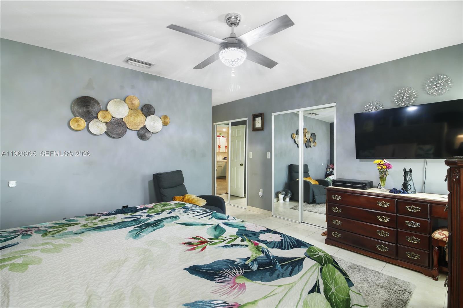 16323 Southwest 103rd Place Miami, FL 33157 - Photo 17 of 42 a bedroom with a bed and a flat screen tv