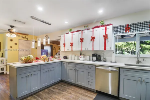 a kitchen with a sink window and cabinets