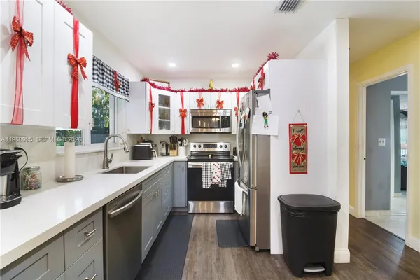 a kitchen with stainless steel appliances granite countertop a refrigerator and a sink