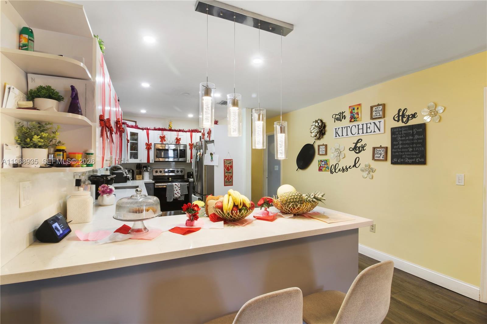 16323 Southwest 103rd Place Miami, FL 33157 - Photo 21 of 42 a room with stainless steel appliances kitchen island granite countertop a sink and cabinets