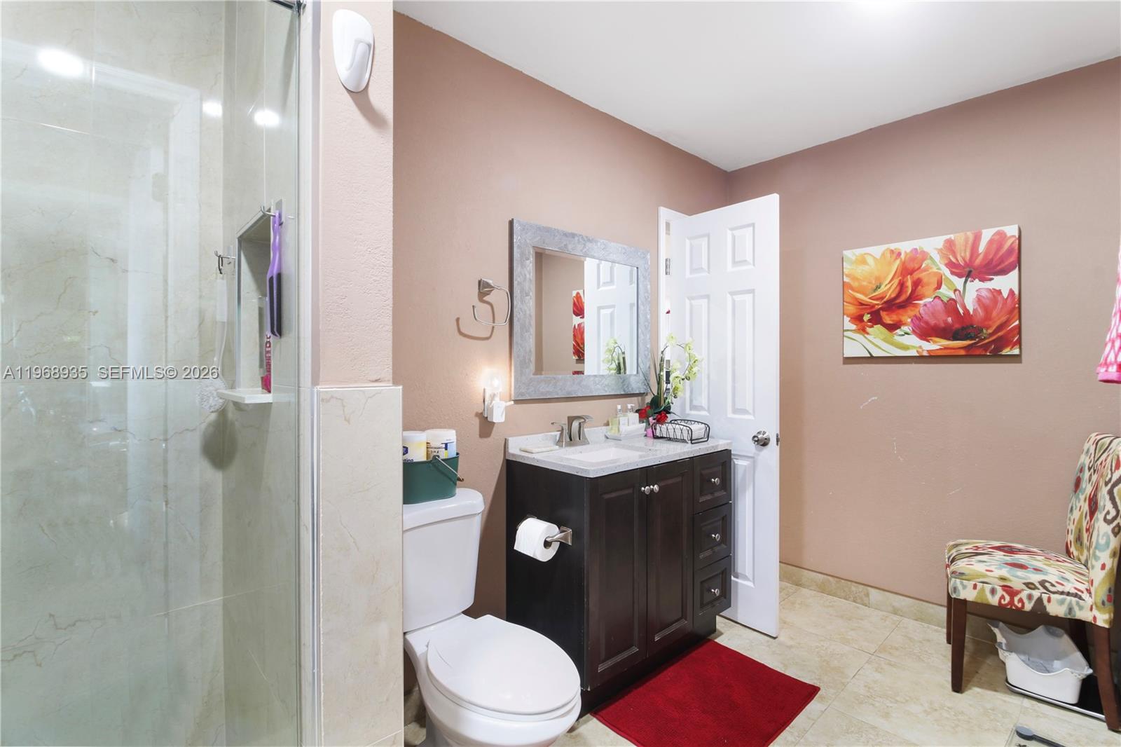 16323 Southwest 103rd Place Miami, FL 33157 - Photo 22 of 42 a bathroom with a toilet a sink and a mirror