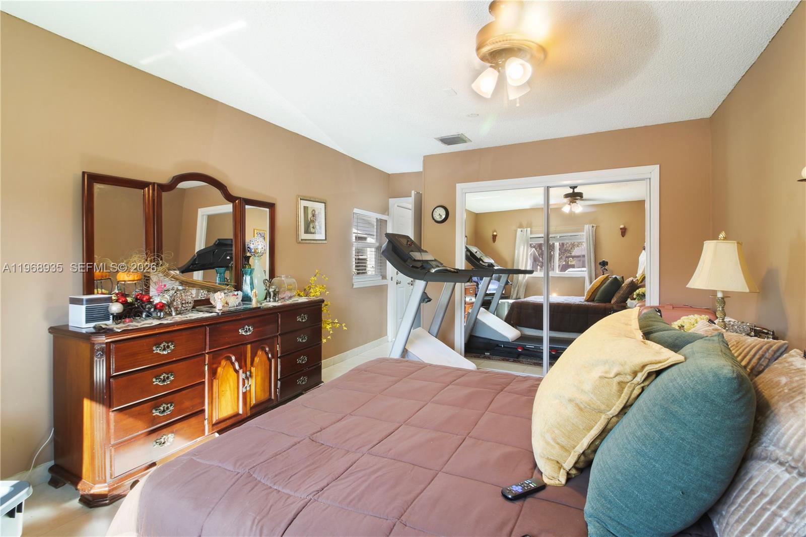 16323 Southwest 103rd Place Miami, FL 33157 - Photo 23 of 42 a bed room with a bed and a mirror