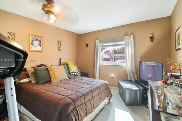 a bedroom with a bed and a tv