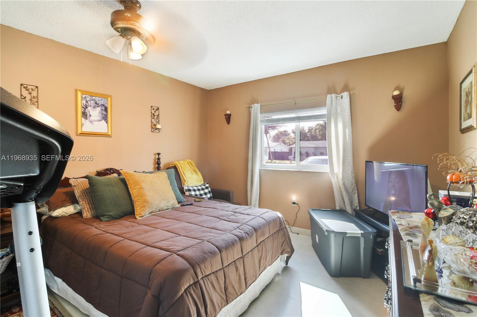 16323 Southwest 103rd Place Miami, FL 33157 - Photo 24 of 42 a bedroom with a bed and a tv