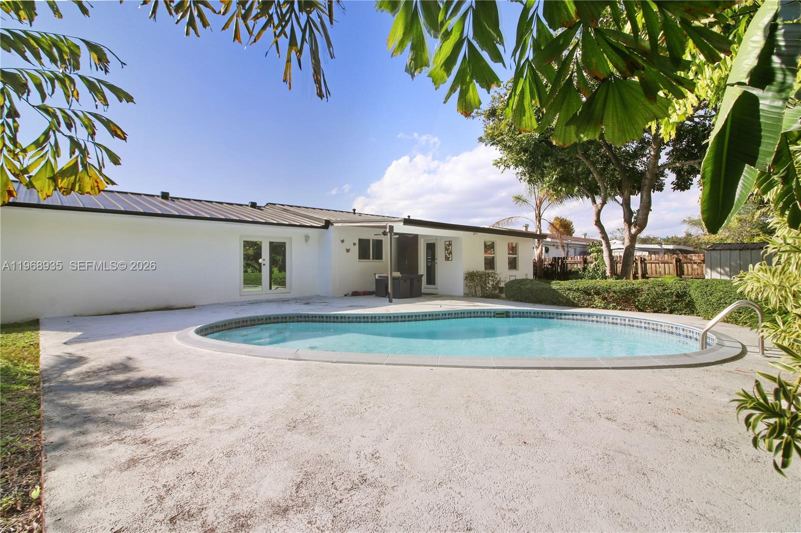 16323 Southwest 103rd Place Miami, FL 33157 - Photo 28 of 42 a front view of a house with a yard