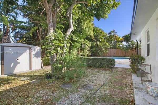 a view of a house with a yard and tree
