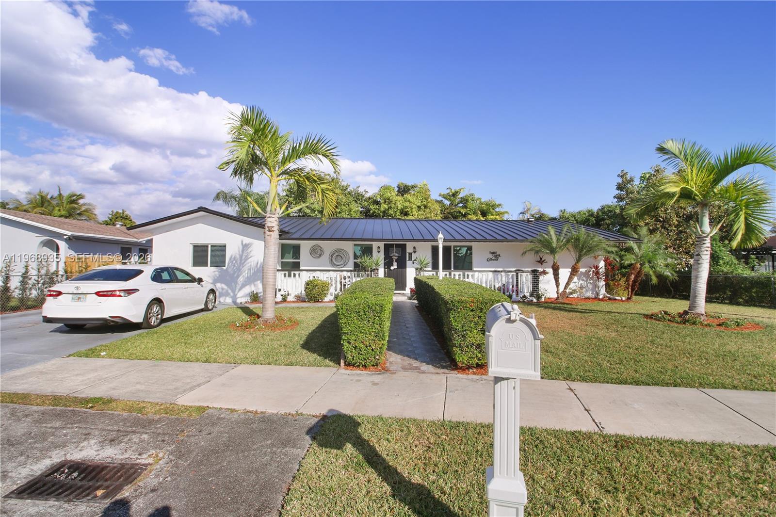 16323 Southwest 103rd Place Miami, FL 33157 - Photo 33 of 42 a front view of a house with a garden and parking