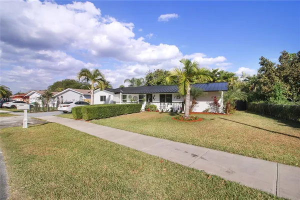 a view of house with outdoor space and swimming pool