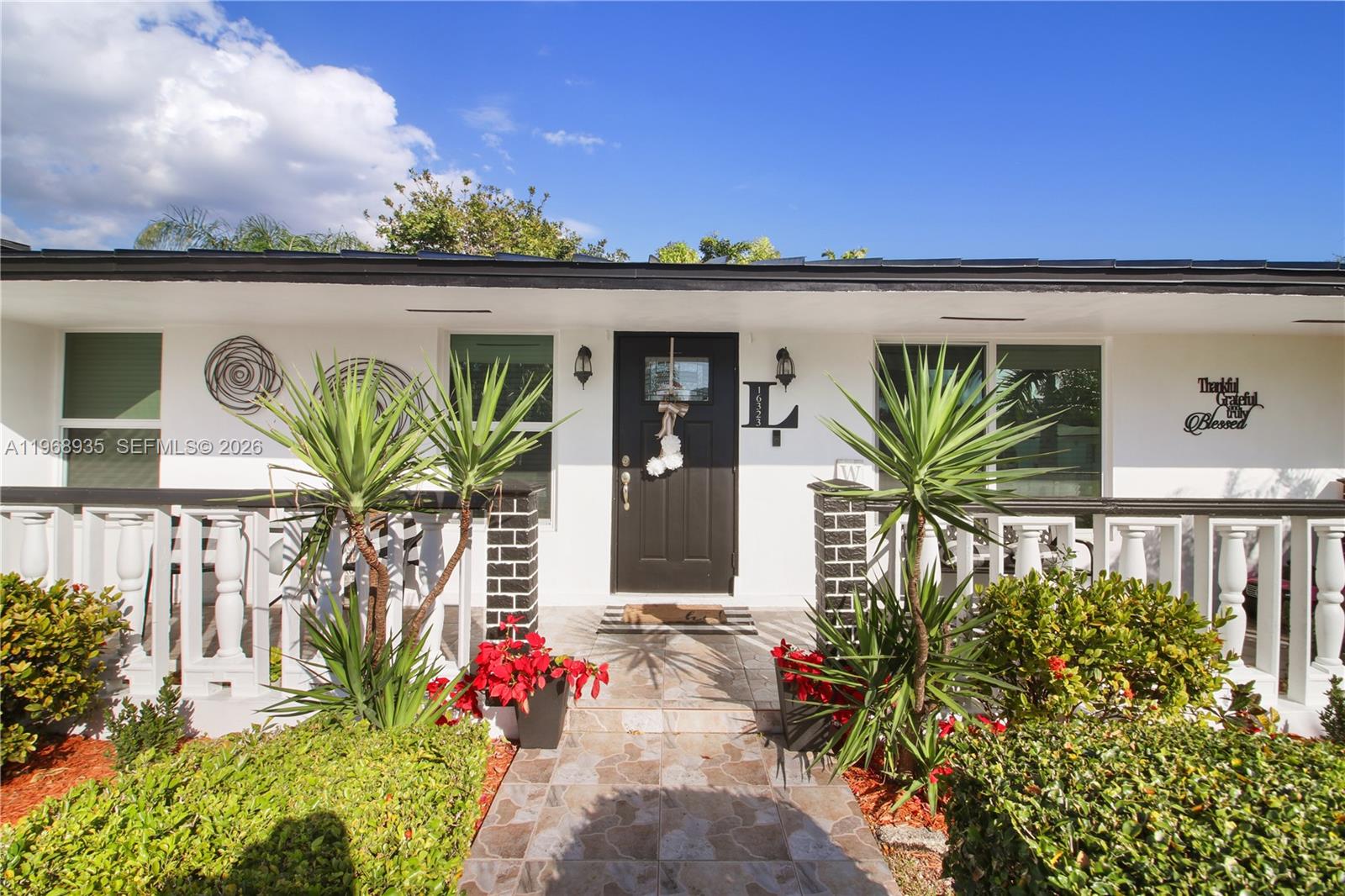 16323 Southwest 103rd Place Miami, FL 33157 - Photo 36 of 42 a front view of a house with garden