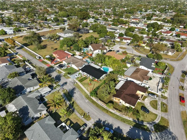 an aerial view of residential houses with outdoor space