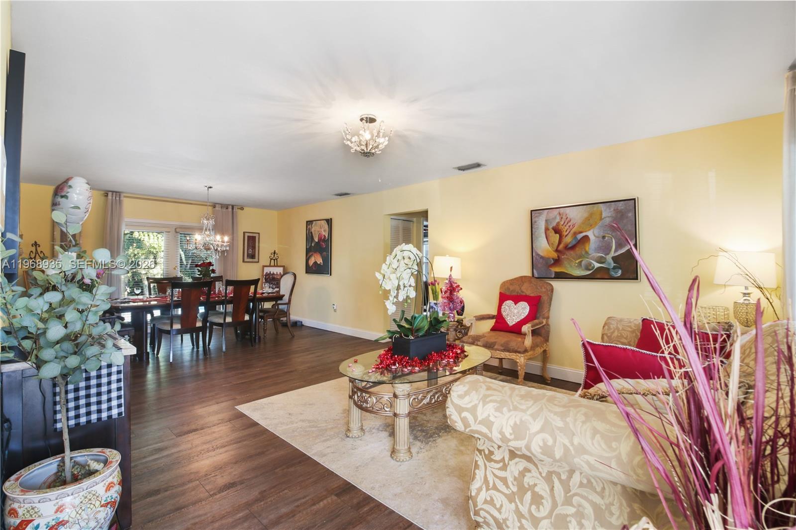 16323 Southwest 103rd Place Miami, FL 33157 - Photo 6 of 42 a living room with furniture and flowers