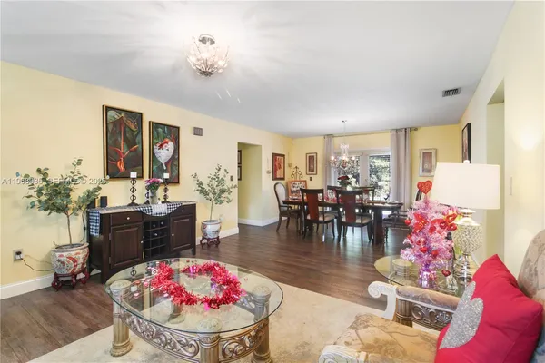 a living room with furniture and a chandelier