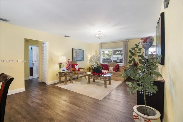 a living room with furniture and a potted plant