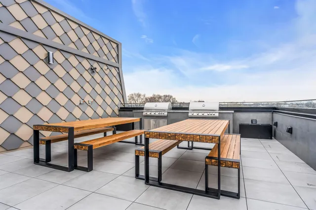 a terrace with outdoor seating and city view