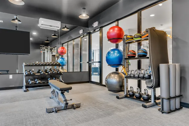 a room with gym equipment and a mirror
