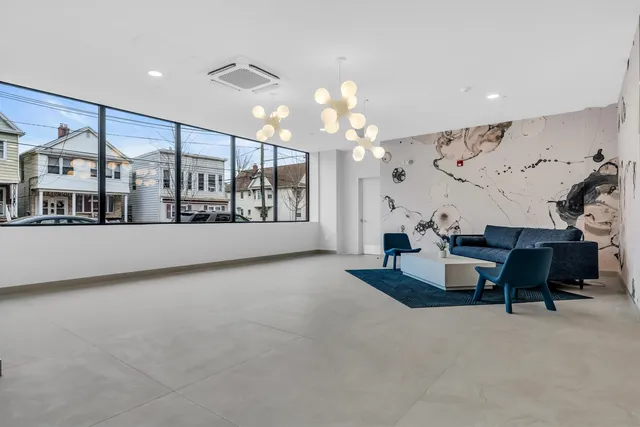 a living room with furniture and a chandelier