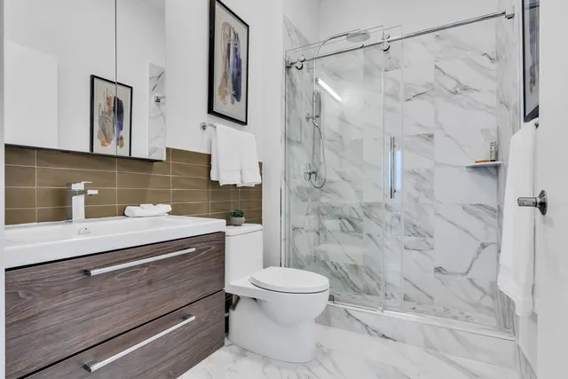a bathroom with a sink toilet and shower