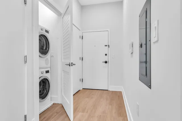 a view of walk in closet with window and hardwood floor