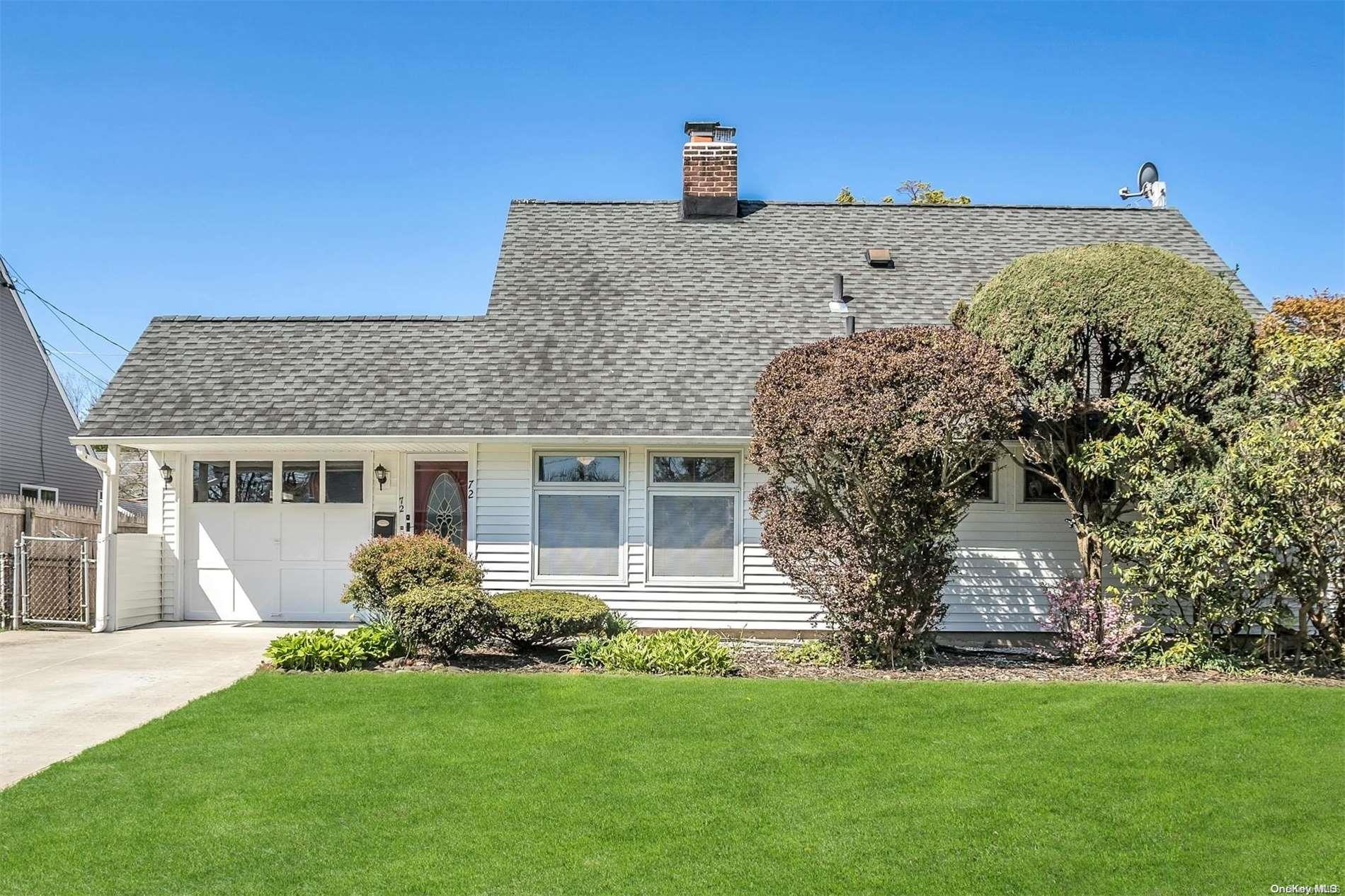 72 Blacksmith Road Levittown, NY 11756 - Photo 1 of 1 a front view of a house with a garden