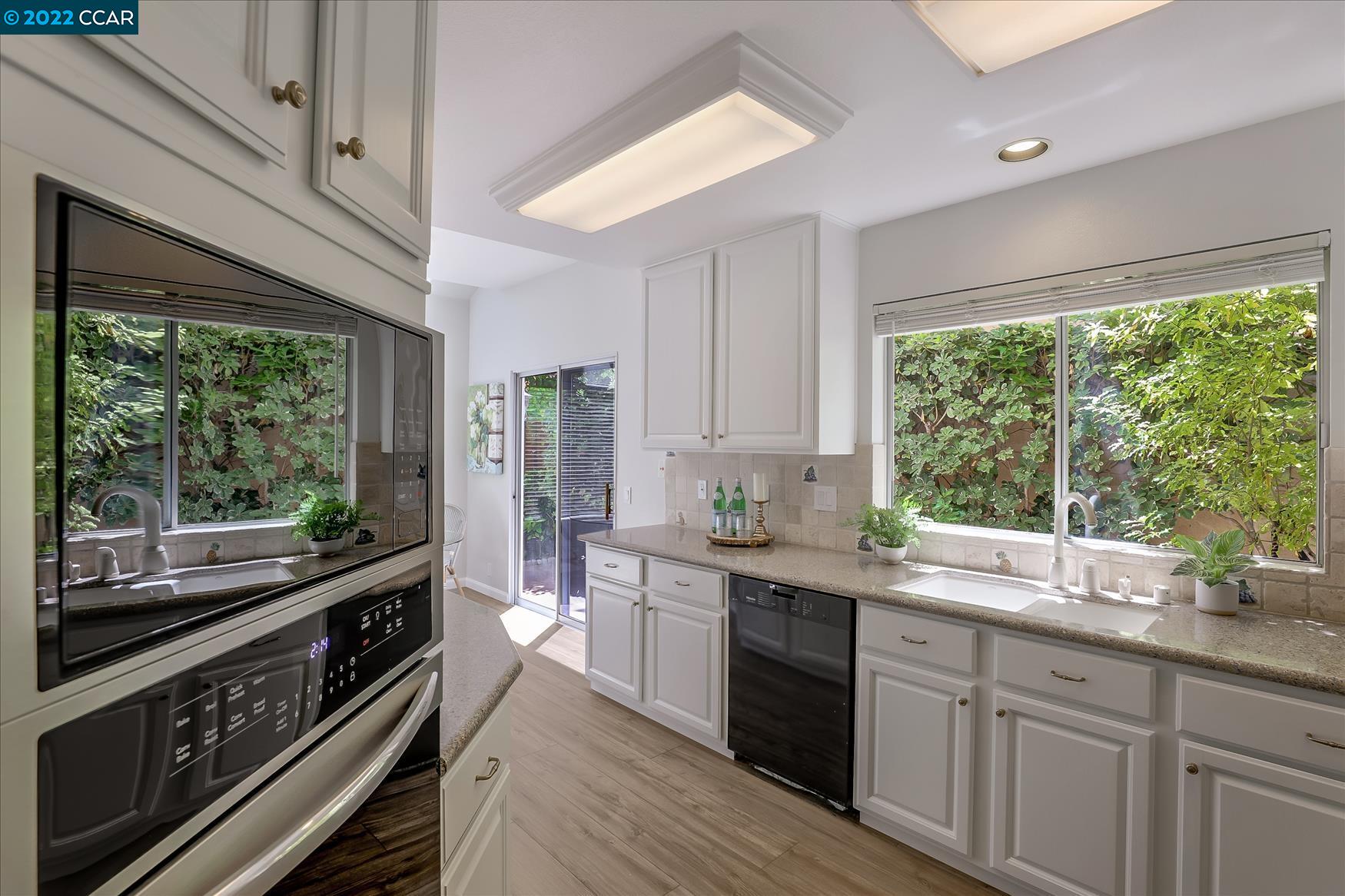 388 Catalan Way San Ramon, CA 94582 - Photo 12 of 52 a kitchen with stainless steel appliances a stove sink and cabinets
