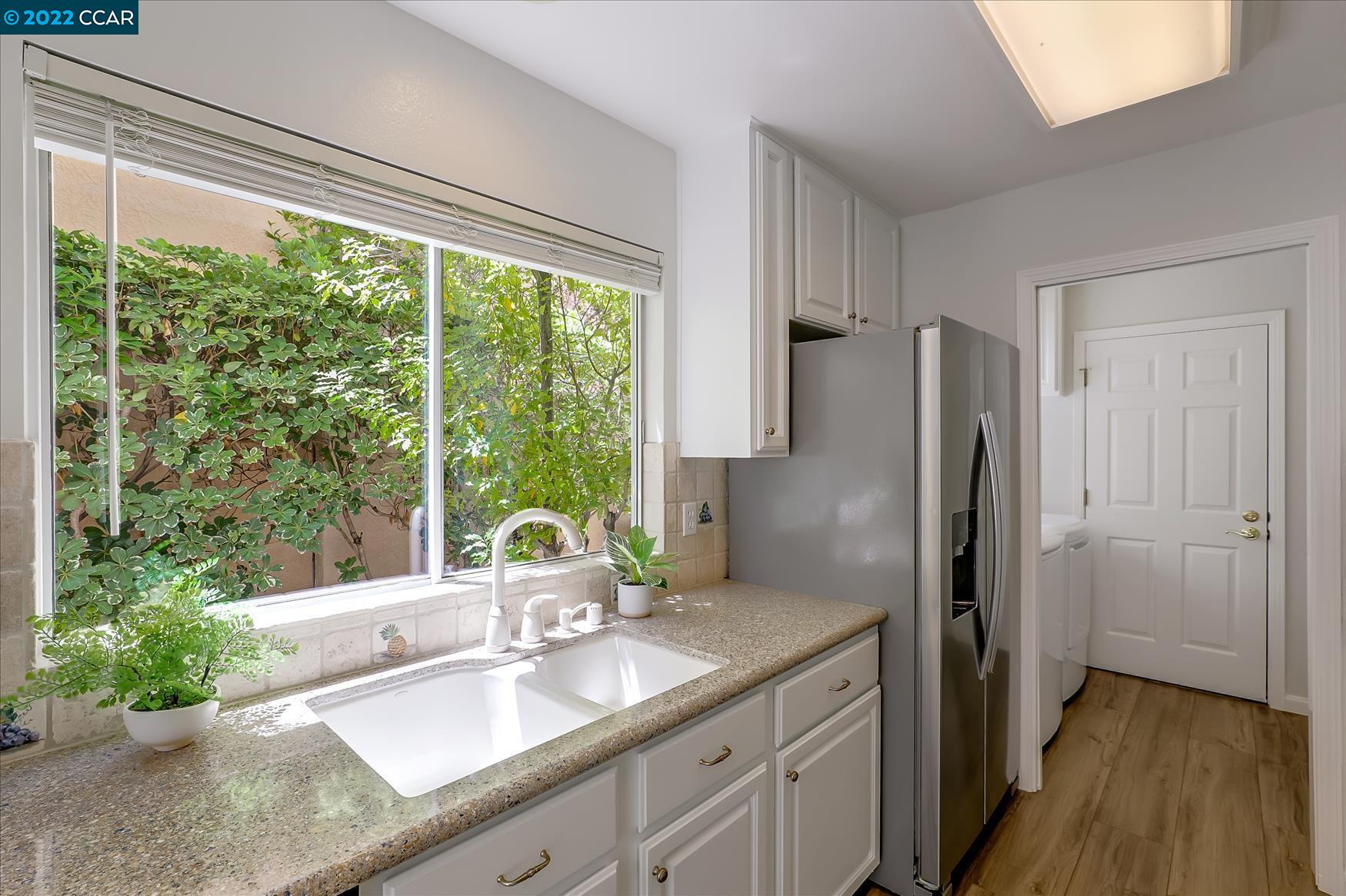388 Catalan Way San Ramon, CA 94582 - Photo 15 of 52 a kitchen with a large window and refrigerator