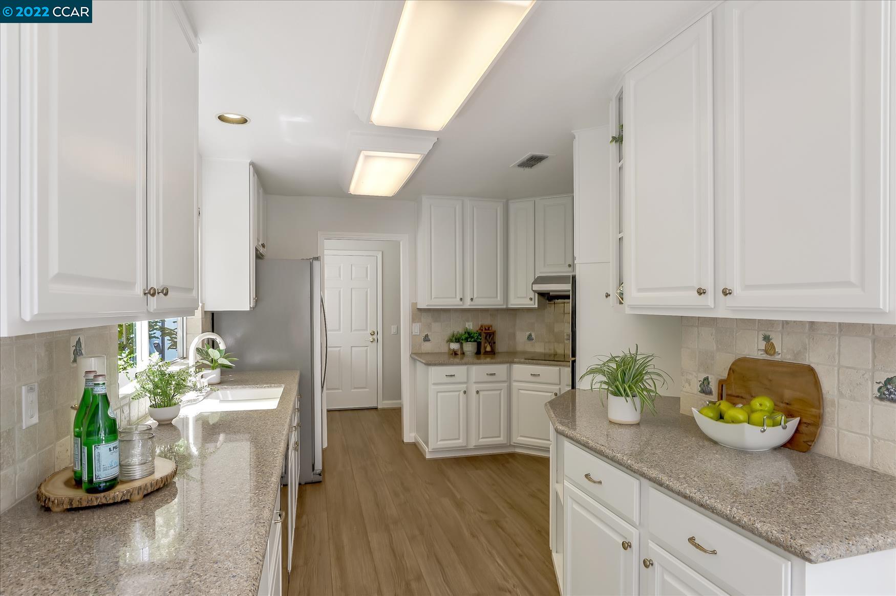 388 Catalan Way San Ramon, CA 94582 - Photo 17 of 52 a kitchen with granite countertop a white sink cabinets and stainless steel appliances