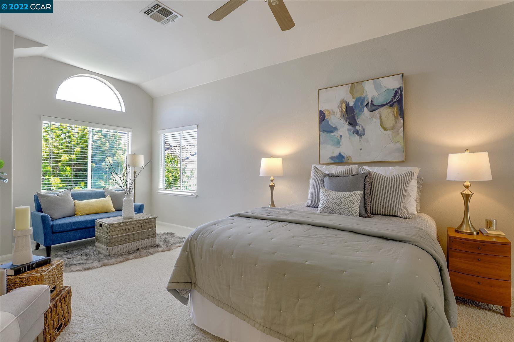 388 Catalan Way San Ramon, CA 94582 - Photo 25 of 52 a spacious bedroom with a bed a couch and a large window