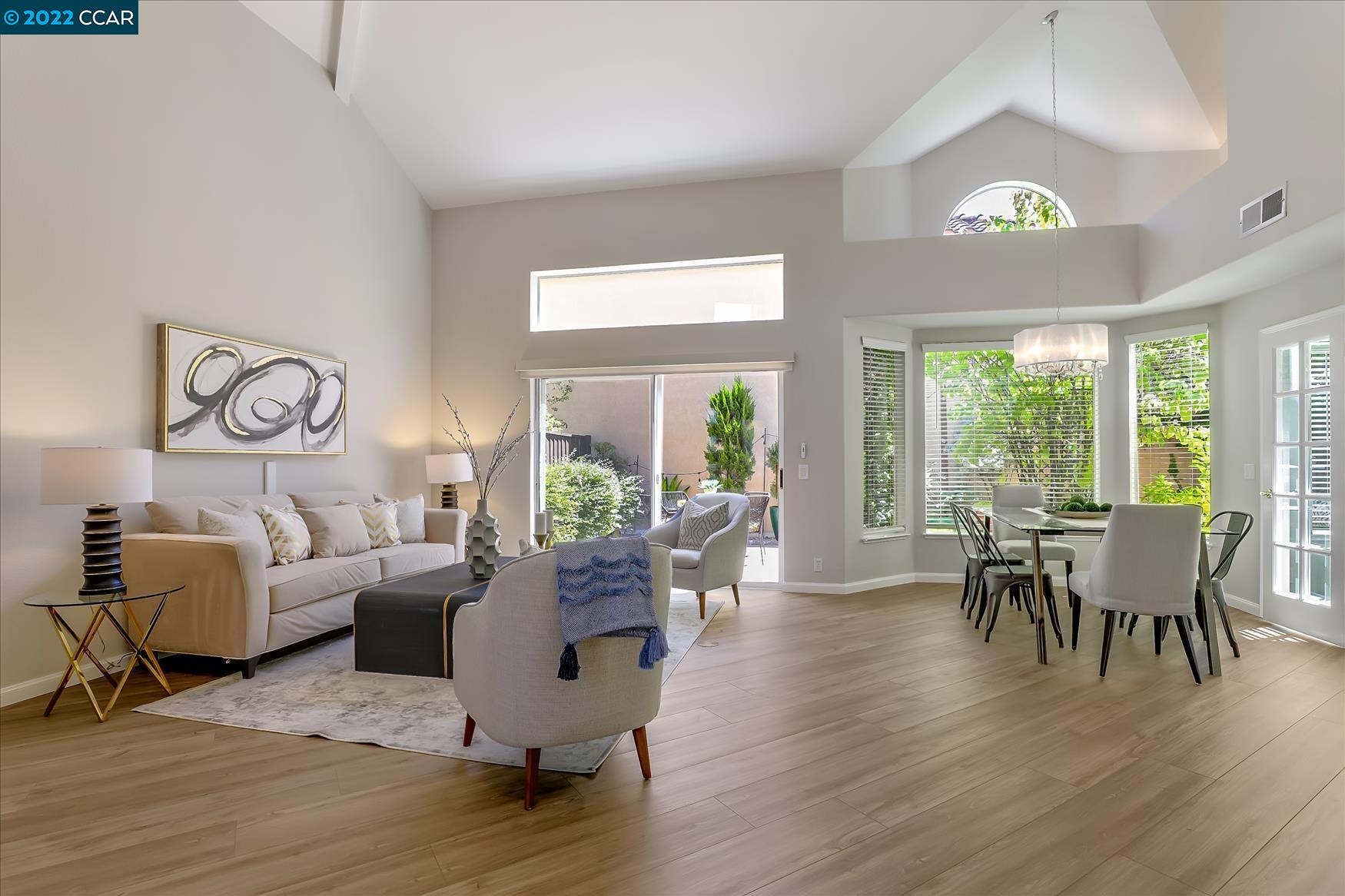 388 Catalan Way San Ramon, CA 94582 - Photo 7 of 52 a dining room with wooden floor a chandelier a glass table and chairs