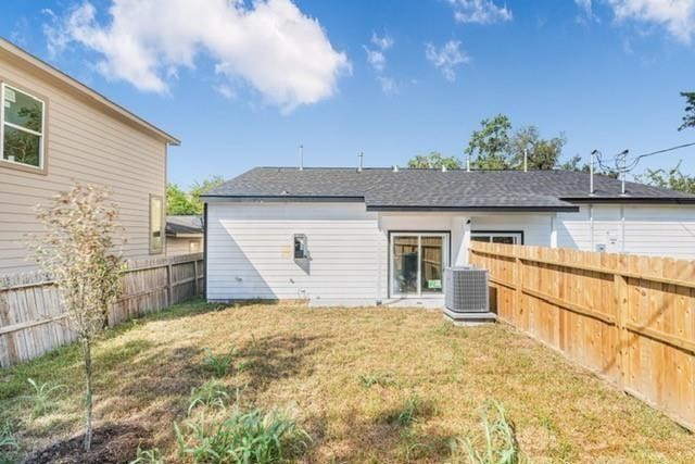 5306 Ridgeway Drive, Unit A Houston, TX 77033 - Photo 14 of 14 Private Backyard – Additional view of the fully fenced backyard showcasing the grassy outdoor space and convenient access to the home through the sliding glass door.