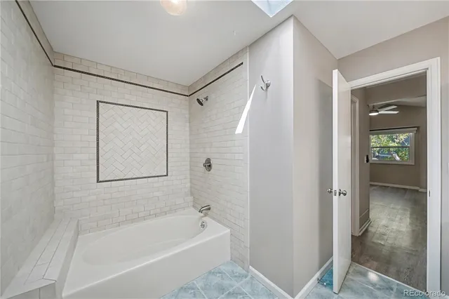 a bathroom with a bathtub and a shower