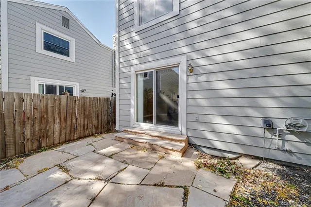 a view of a house with a wooden fence